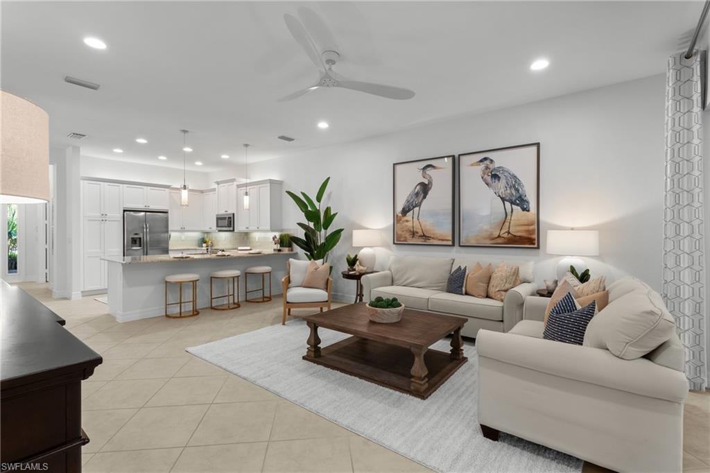 a living room with furniture and view of kitchen