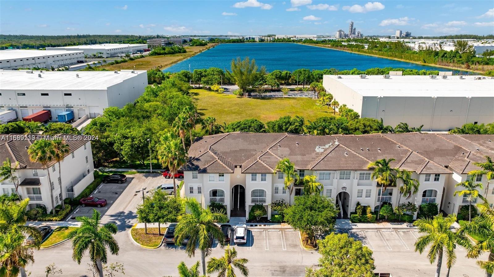 an aerial view of multiple houses with a lake view