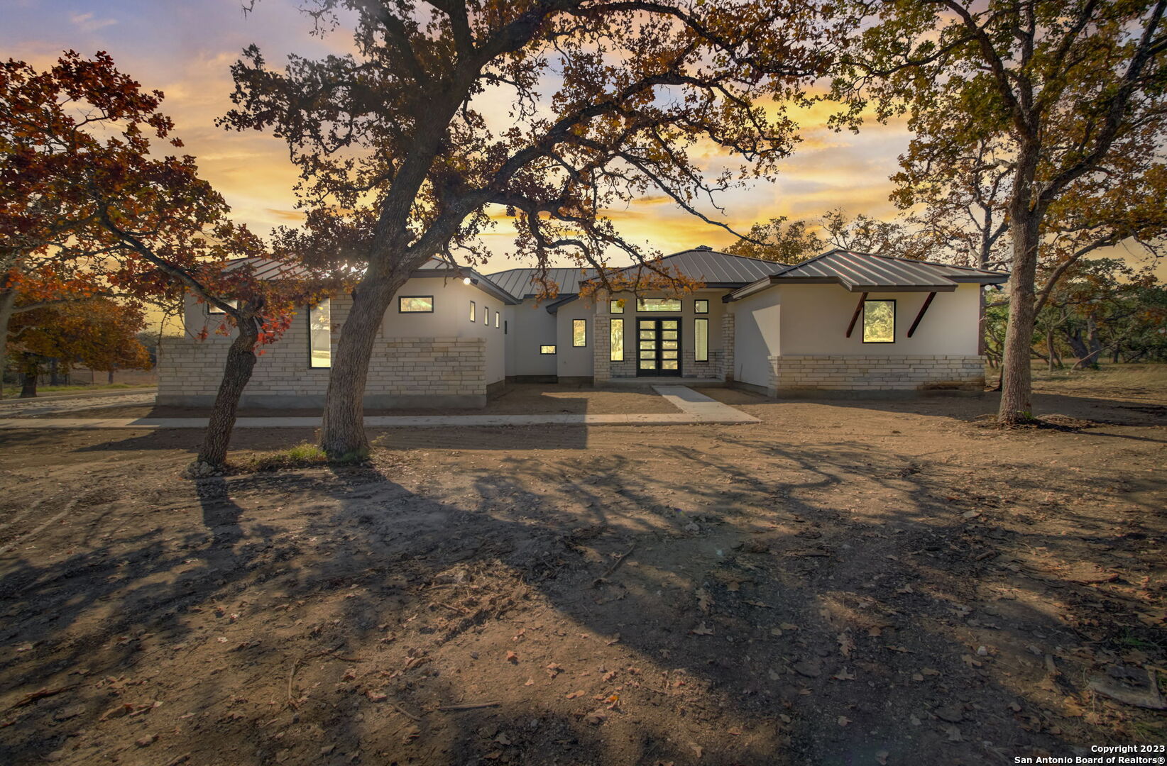 a backyard of a house with large trees