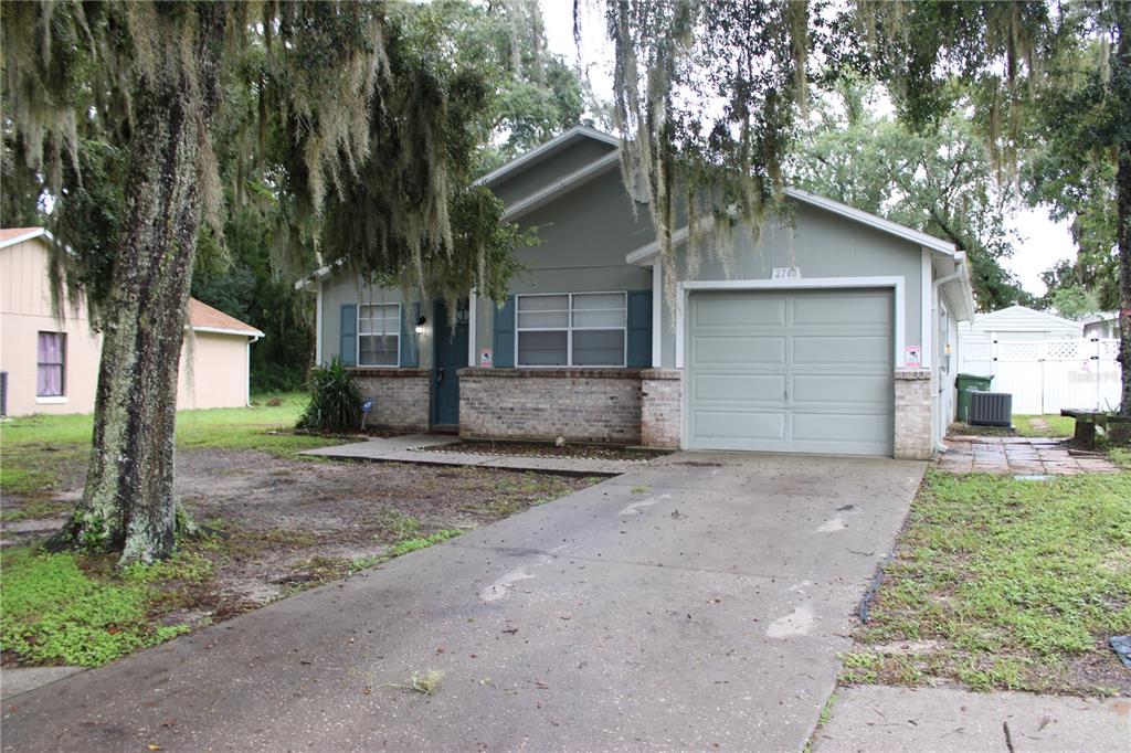 a view of a house with a yard and garage