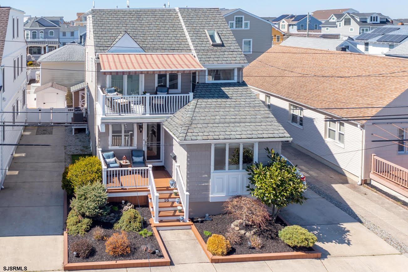 an aerial view of a house with swimming pool outdoor seating