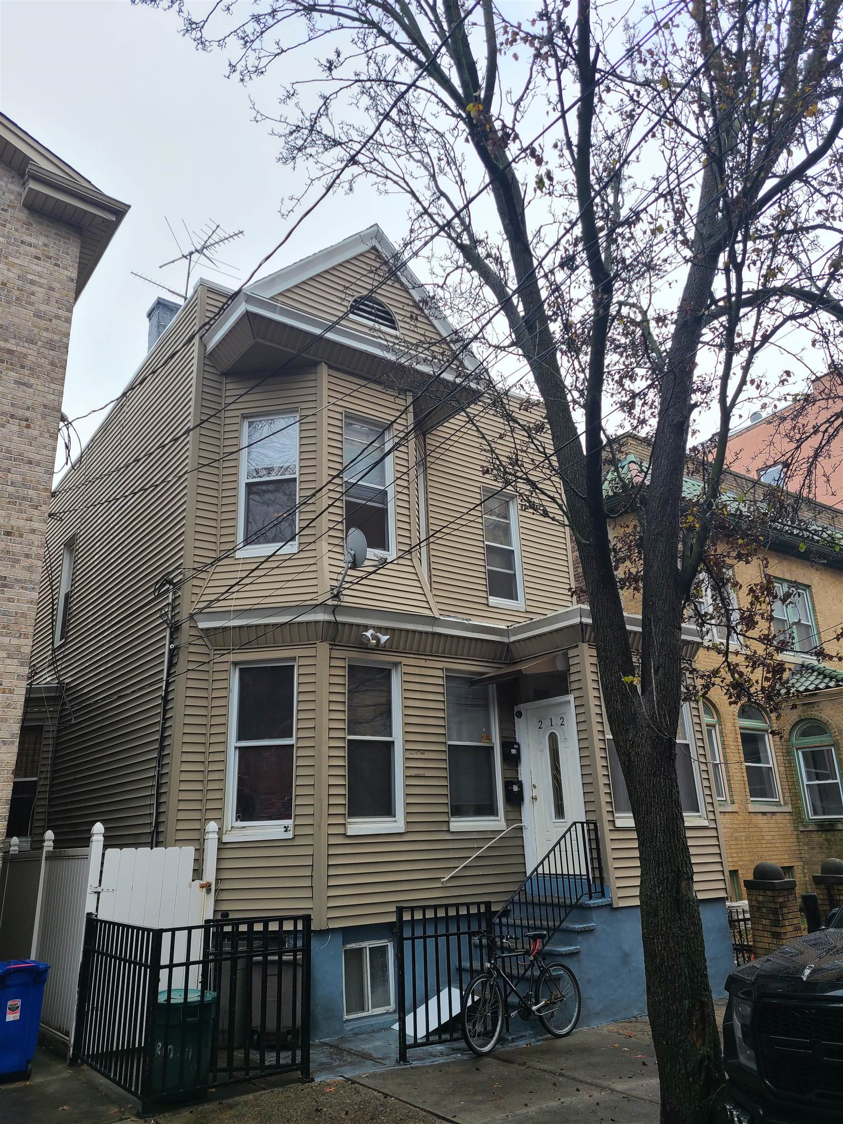 a front view of a house with a tree