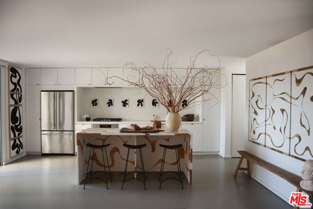 a view of a dining room with furniture and a kitchen