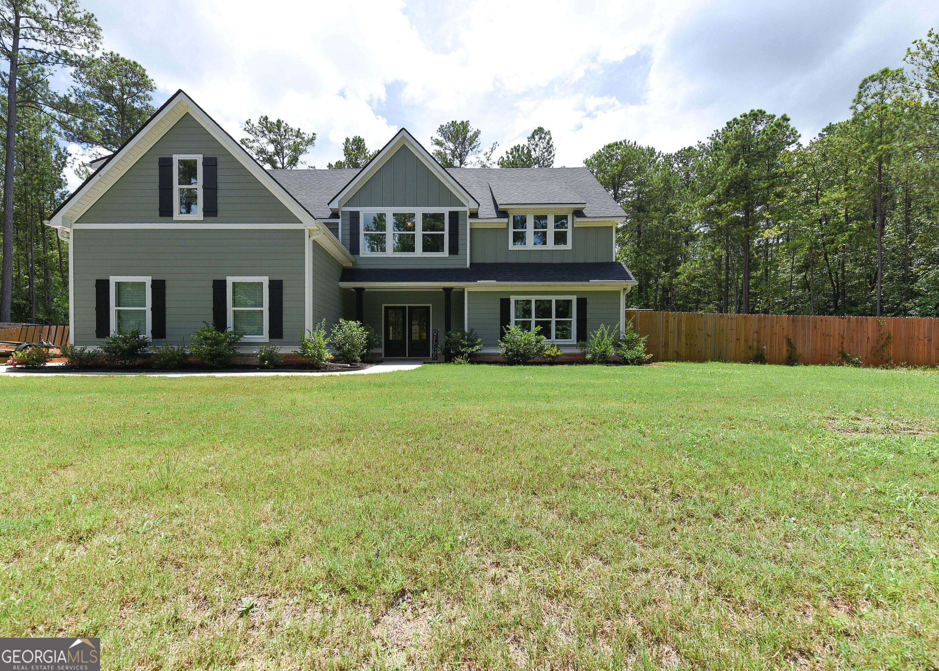 a front view of house with yard and green space