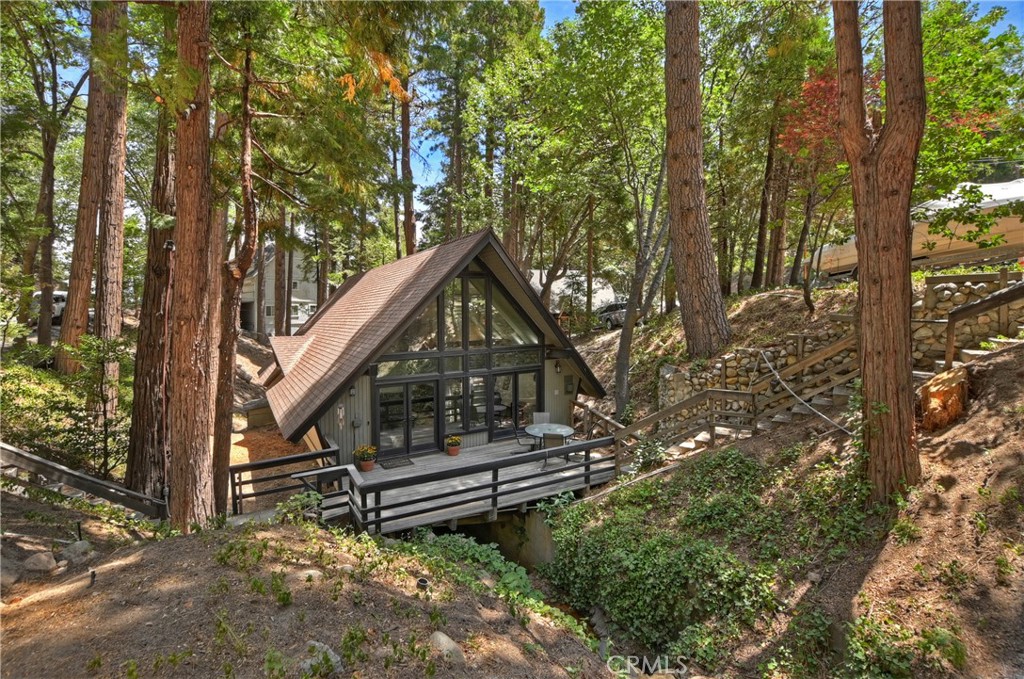 a backyard of a house with wooden stairs and floor to ceiling