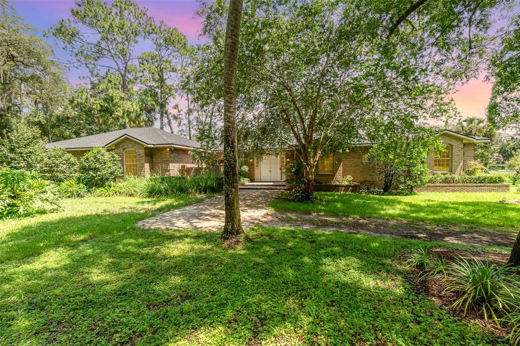 a view of a house with a backyard