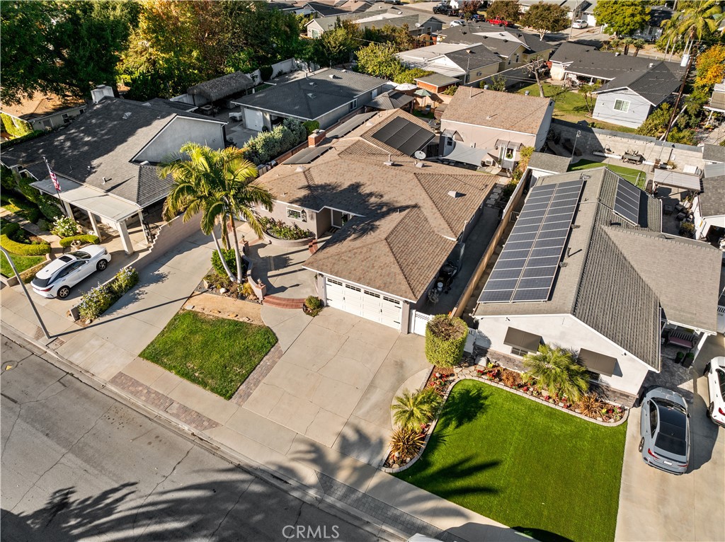 an aerial view of a house with garden space and street view