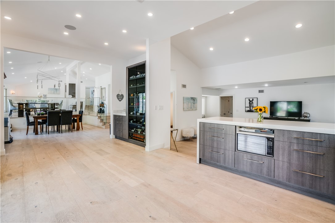 a open kitchen with lots of counter space dining table and stainless steel appliances