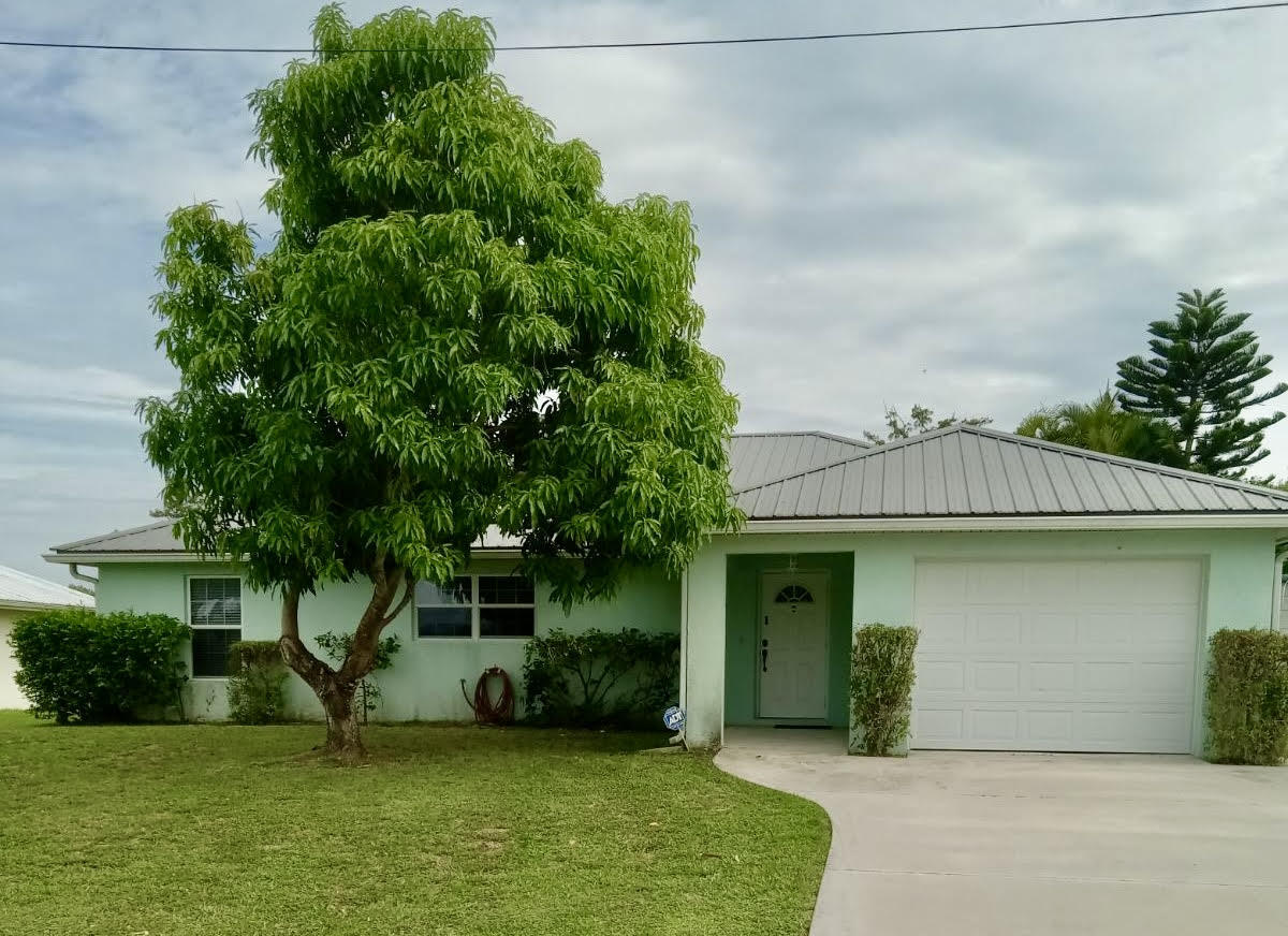 a front view of a house with a garden