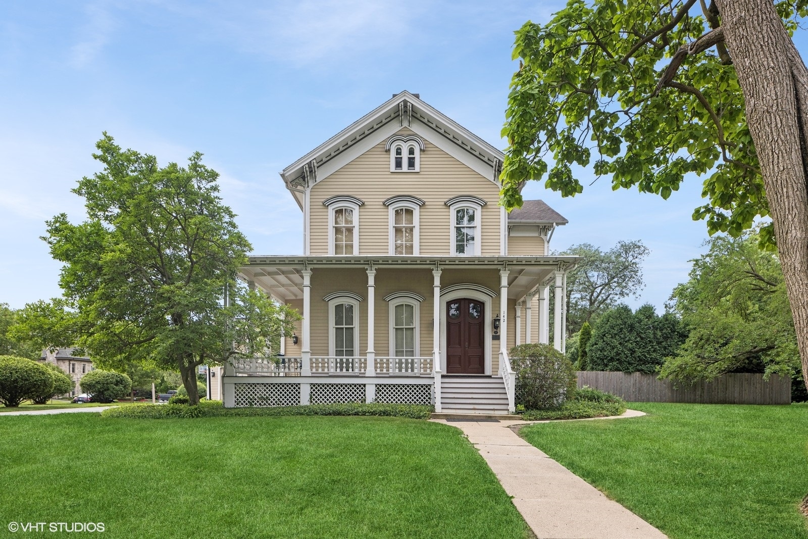 a front view of a house with a garden