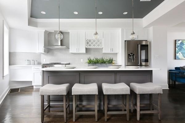 a kitchen with stainless steel appliances granite countertop a table chairs sink and cabinets