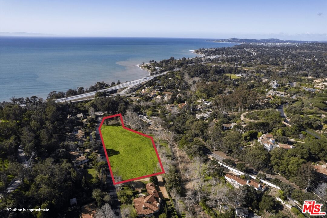 an aerial view of a houses with a yard