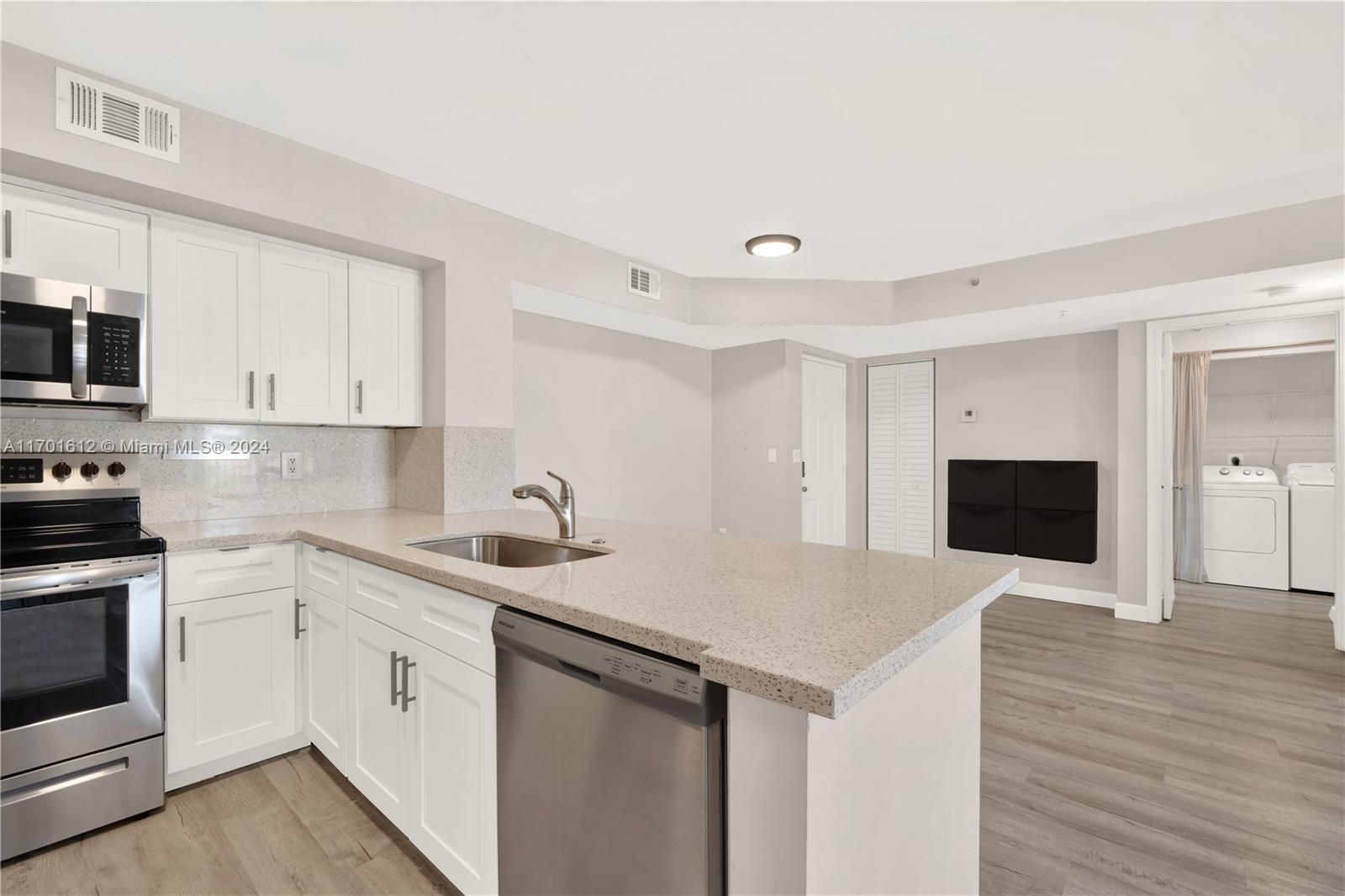 a kitchen with a sink and white cabinets