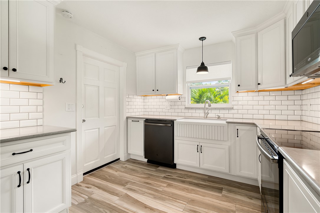 a kitchen with white cabinets and white appliances