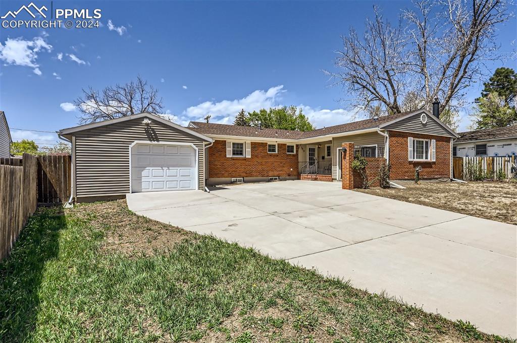 Ranch-style home with a garage and covered porch