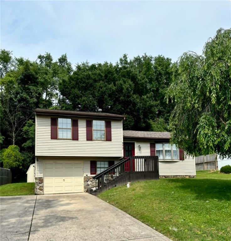 a house that has a tree in front of the house