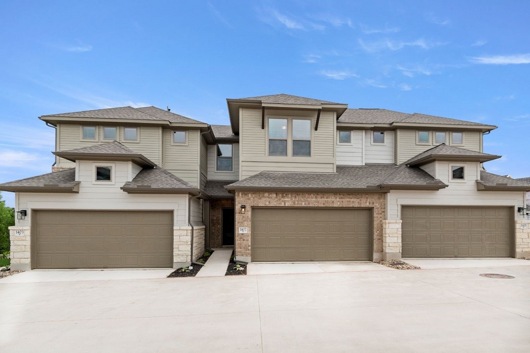 a front view of a house with garage