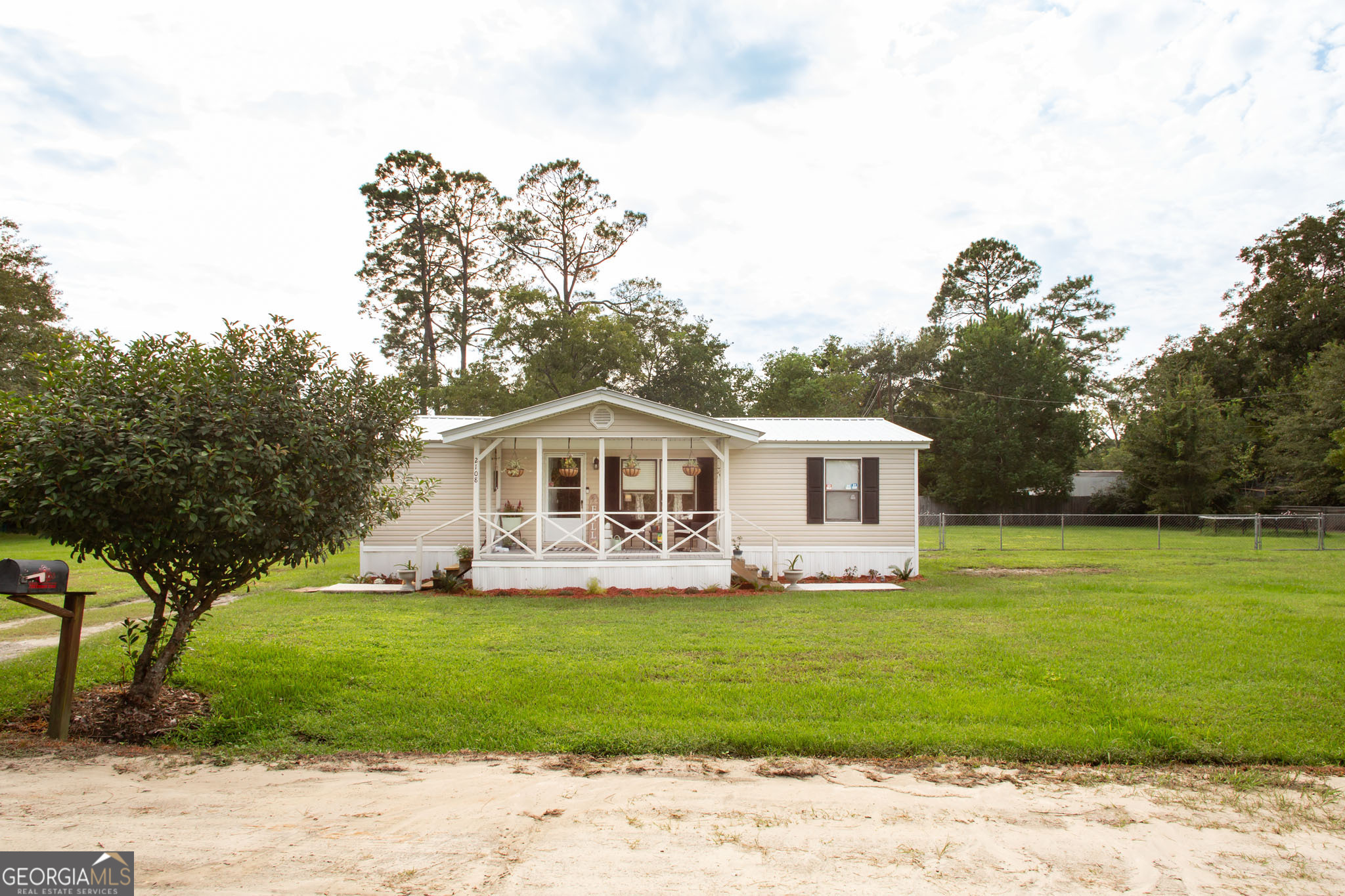 a front view of a house with a garden