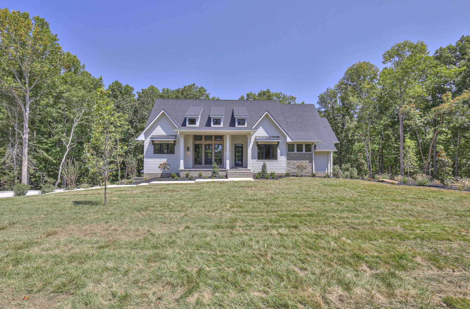 a front view of a house with a garden