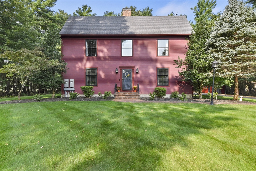 a view of a brick house with a yard