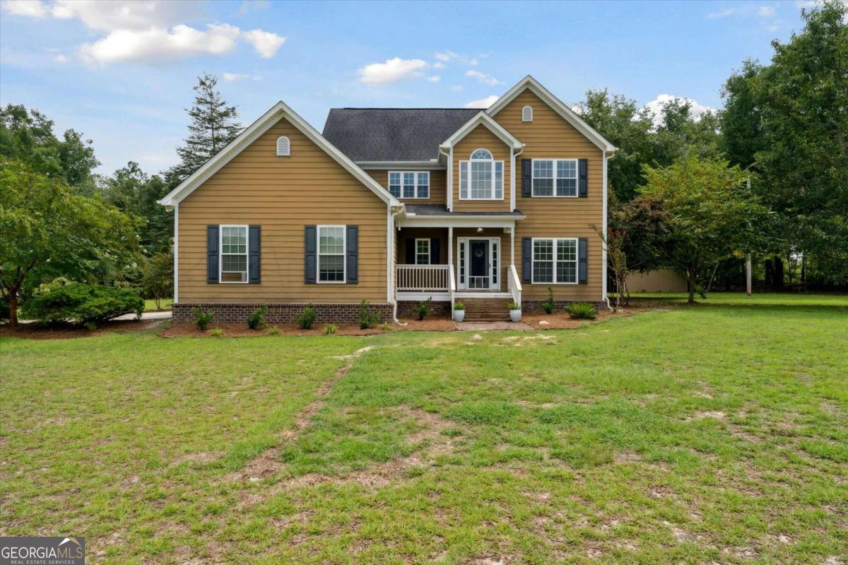 a front view of a house with a yard