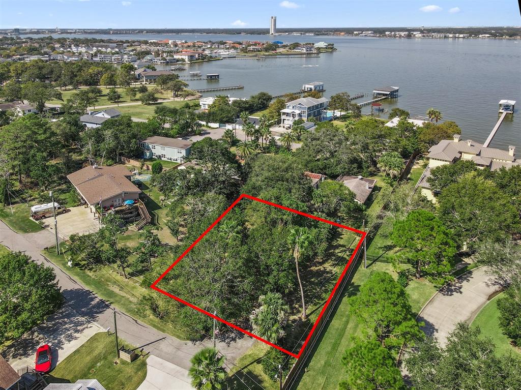 an aerial view of lake houses and trees