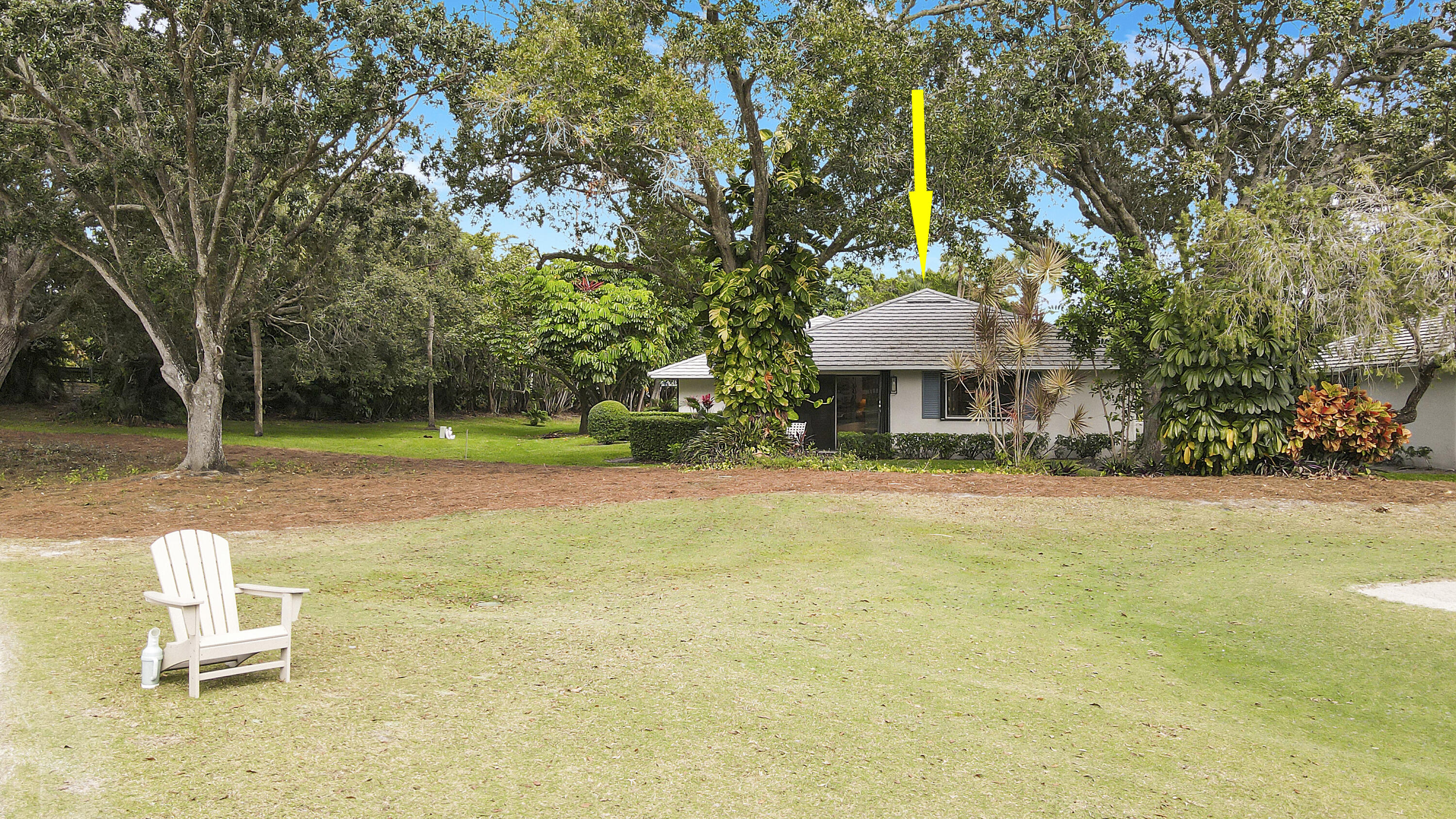 a front view of a house with a yard and trees