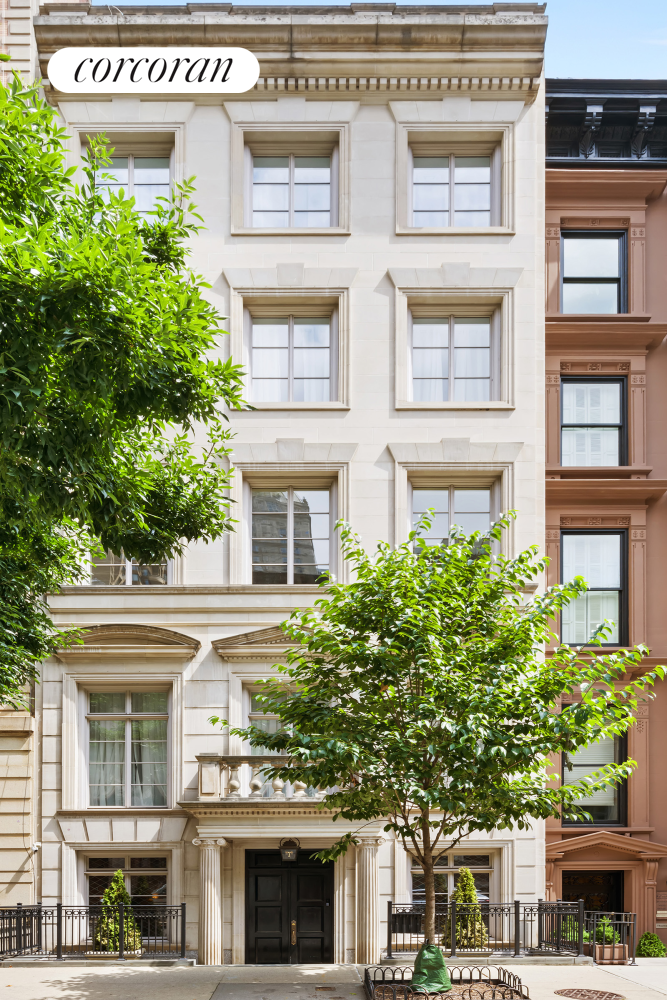 a front view of a multi story building with a yard