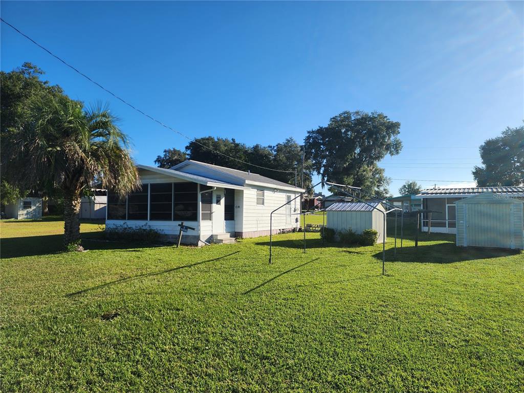 a view of a house with a yard and sitting area