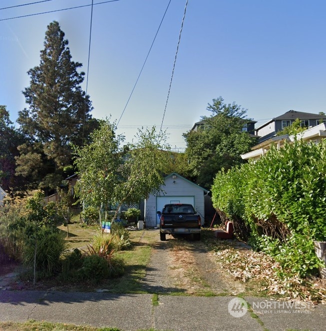 a view of a house with truck parked on the road