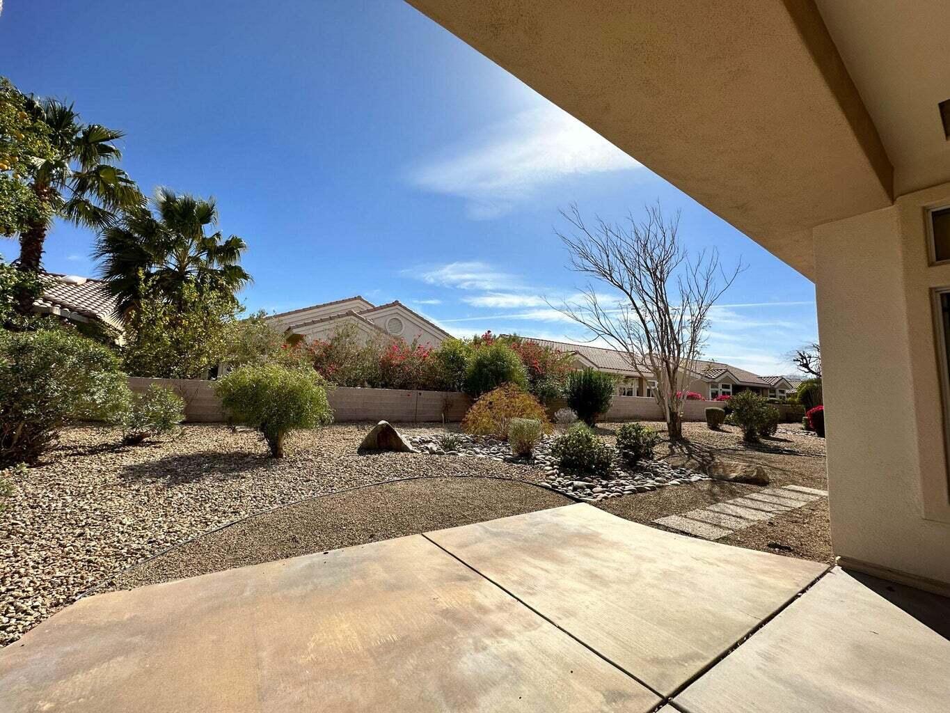 a view of a backyard with sitting area