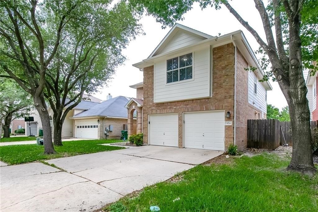 a front view of a house with a yard and garage