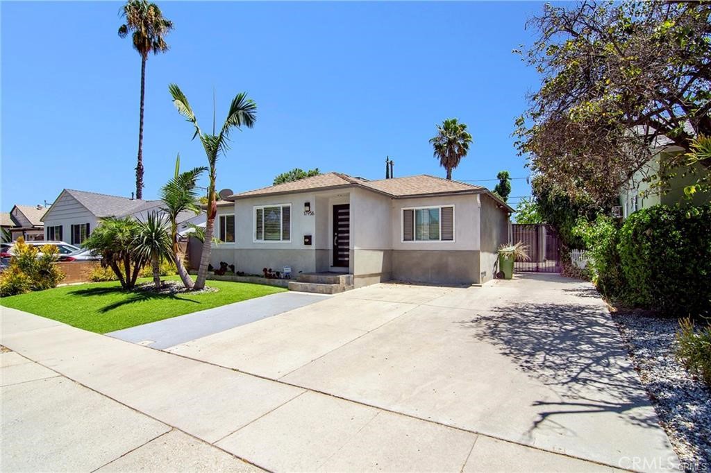 a front view of a house with a yard and a garage