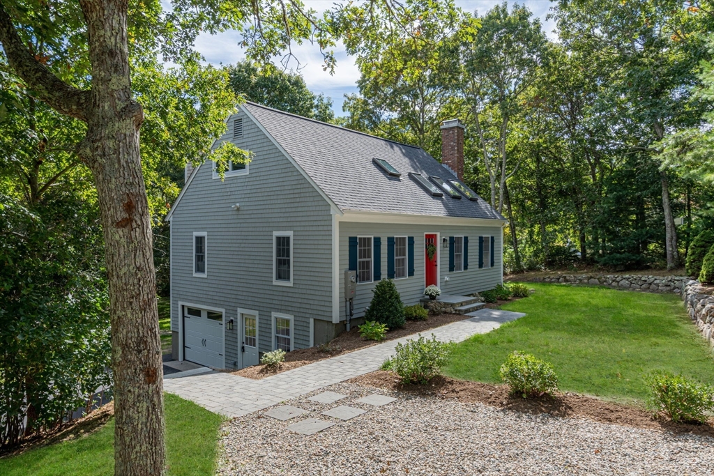 a front view of house with yard and green space