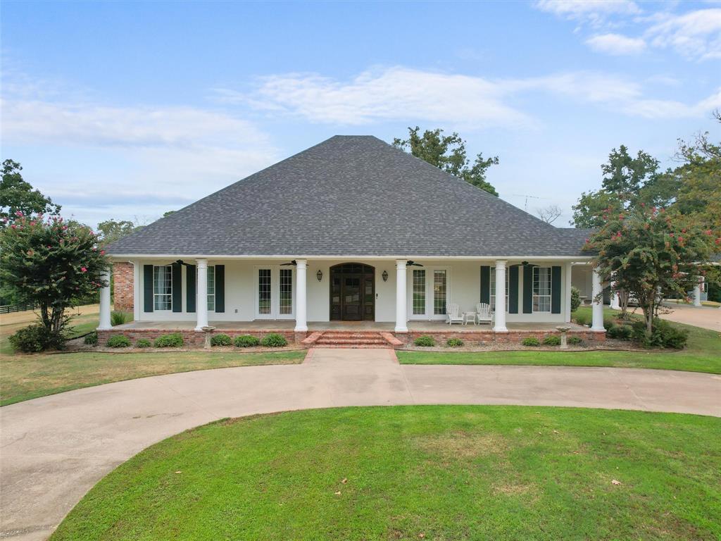 a front view of house with yard and green space