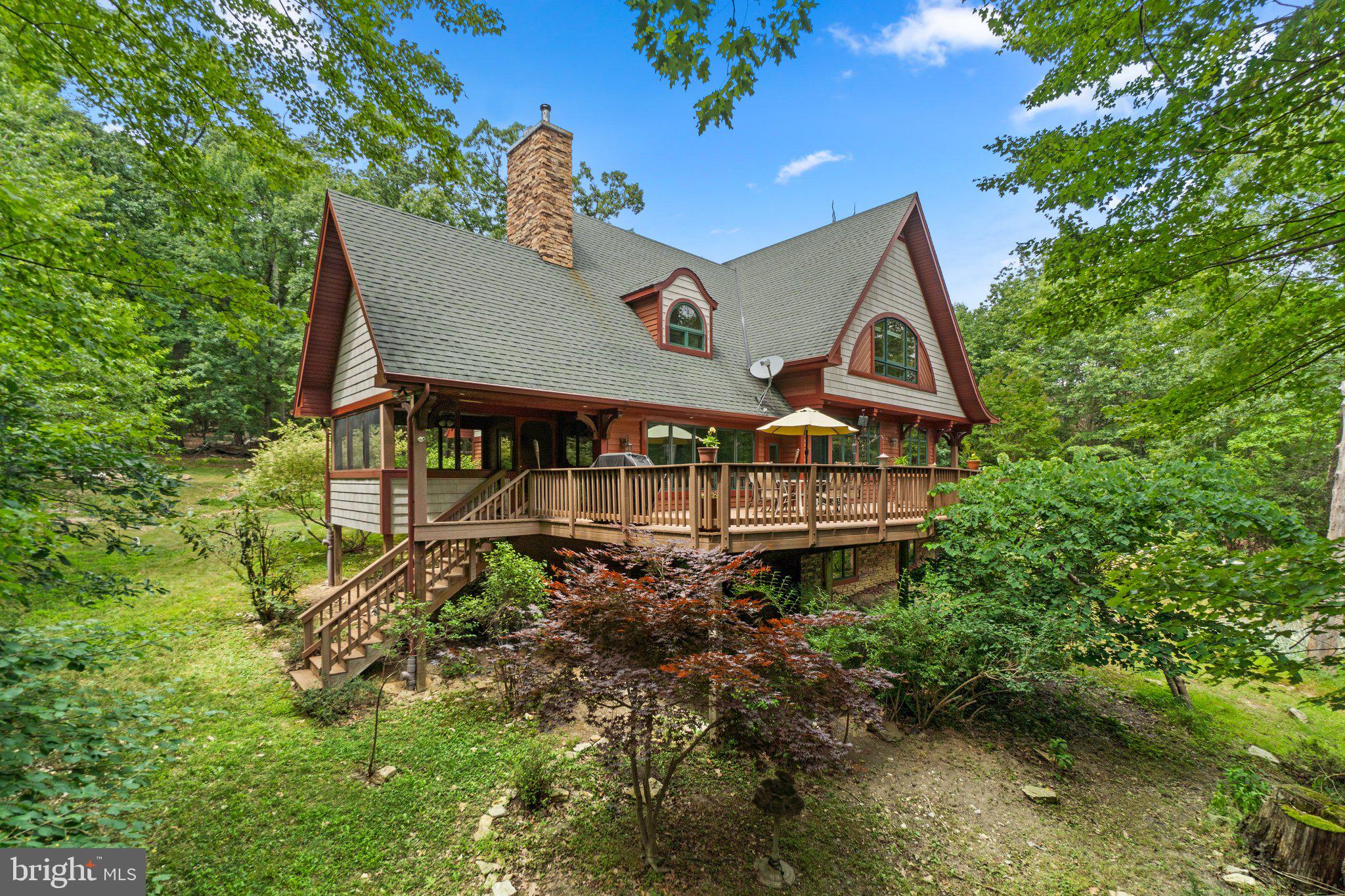 a aerial view of a house with a yard and potted plants