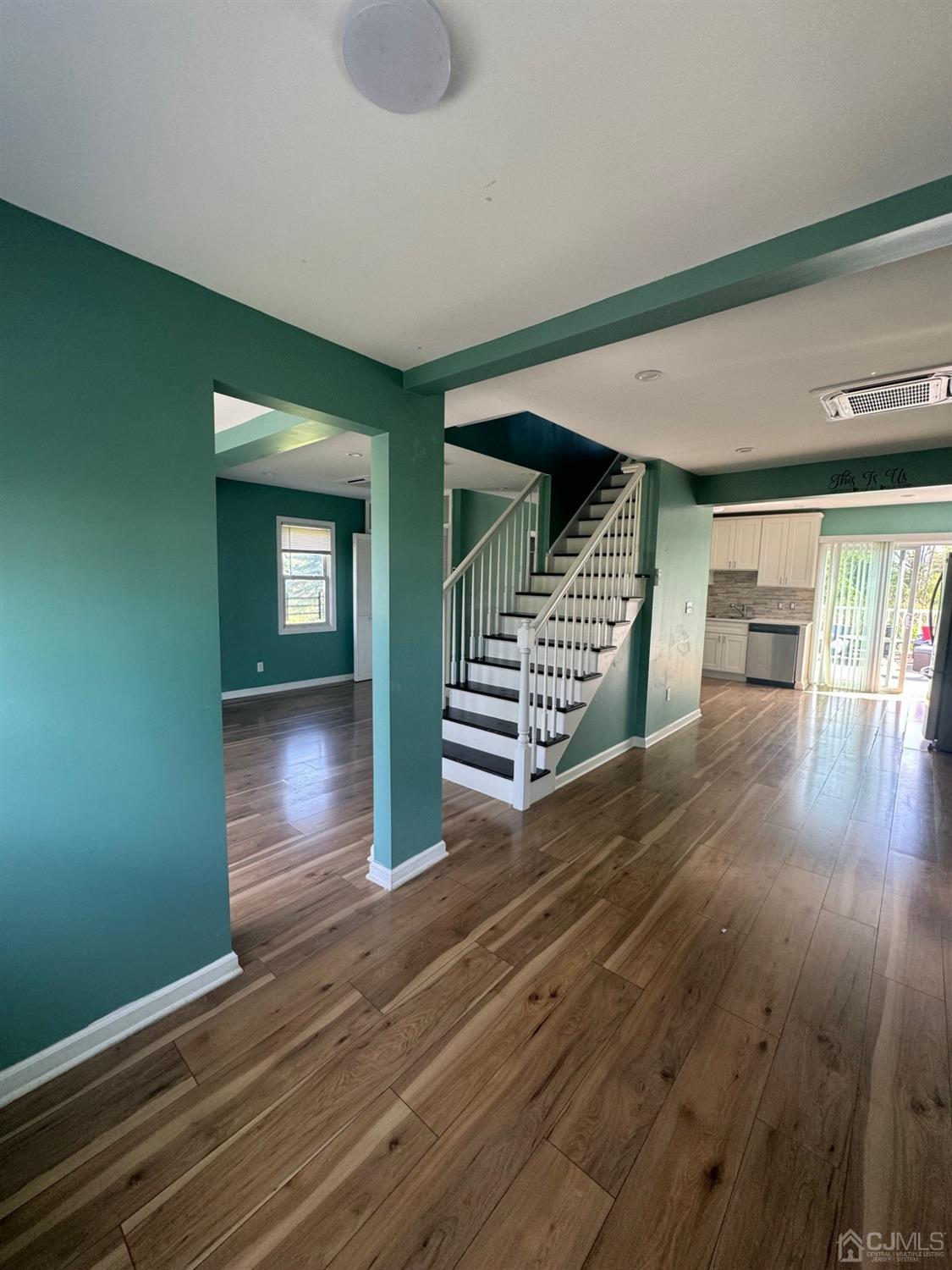 wooden floor in an empty room with a window