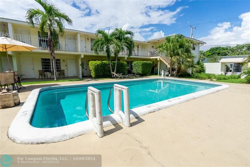 a view of a house with swimming pool and a yard