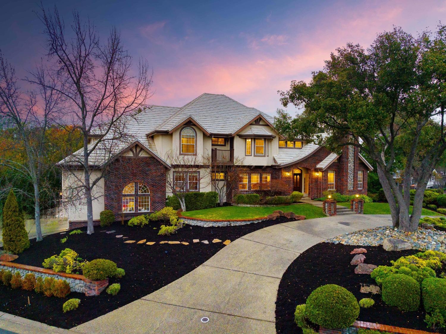 a front view of a house with a yard and outdoor seating