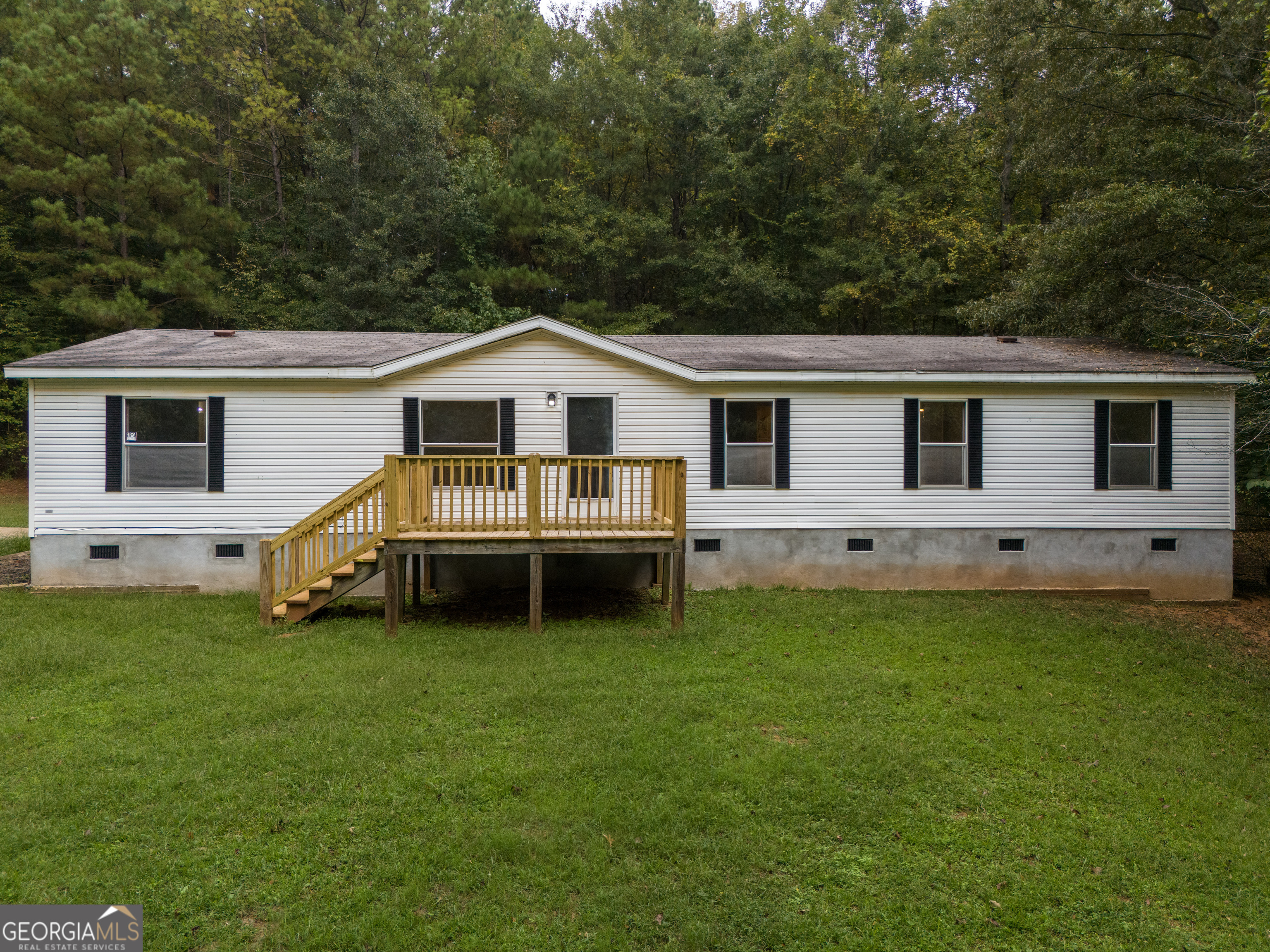 a view of a house with a yard and sitting area