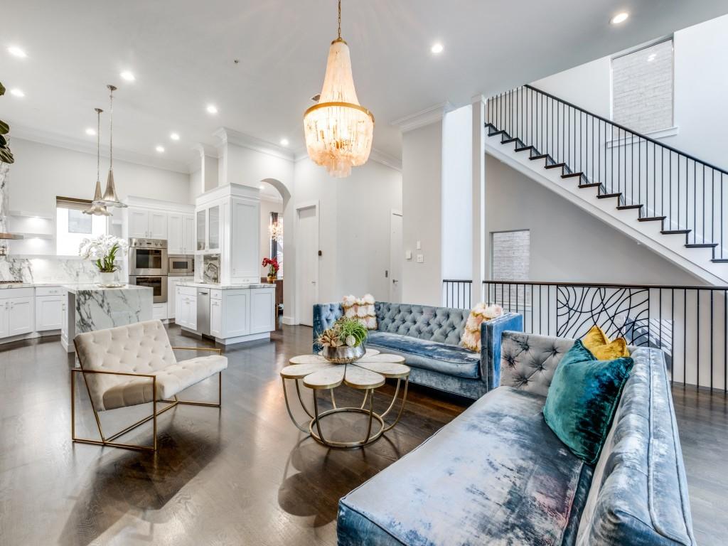 a living room with furniture kitchen view and a chandelier