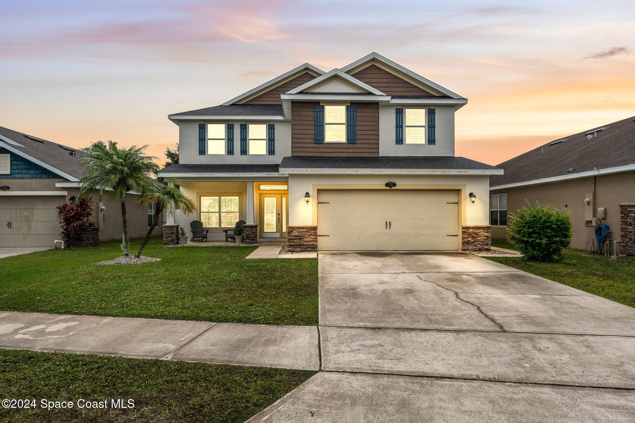 a front view of a house with a yard and garage