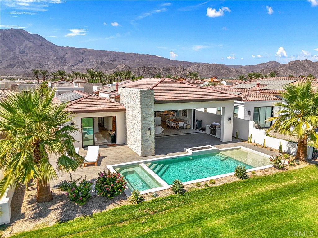 a view of a house with pool and a yard