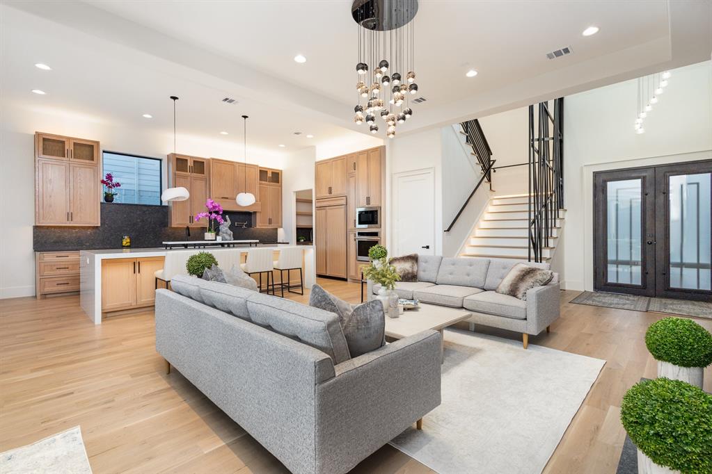 a living room with furniture and a chandelier