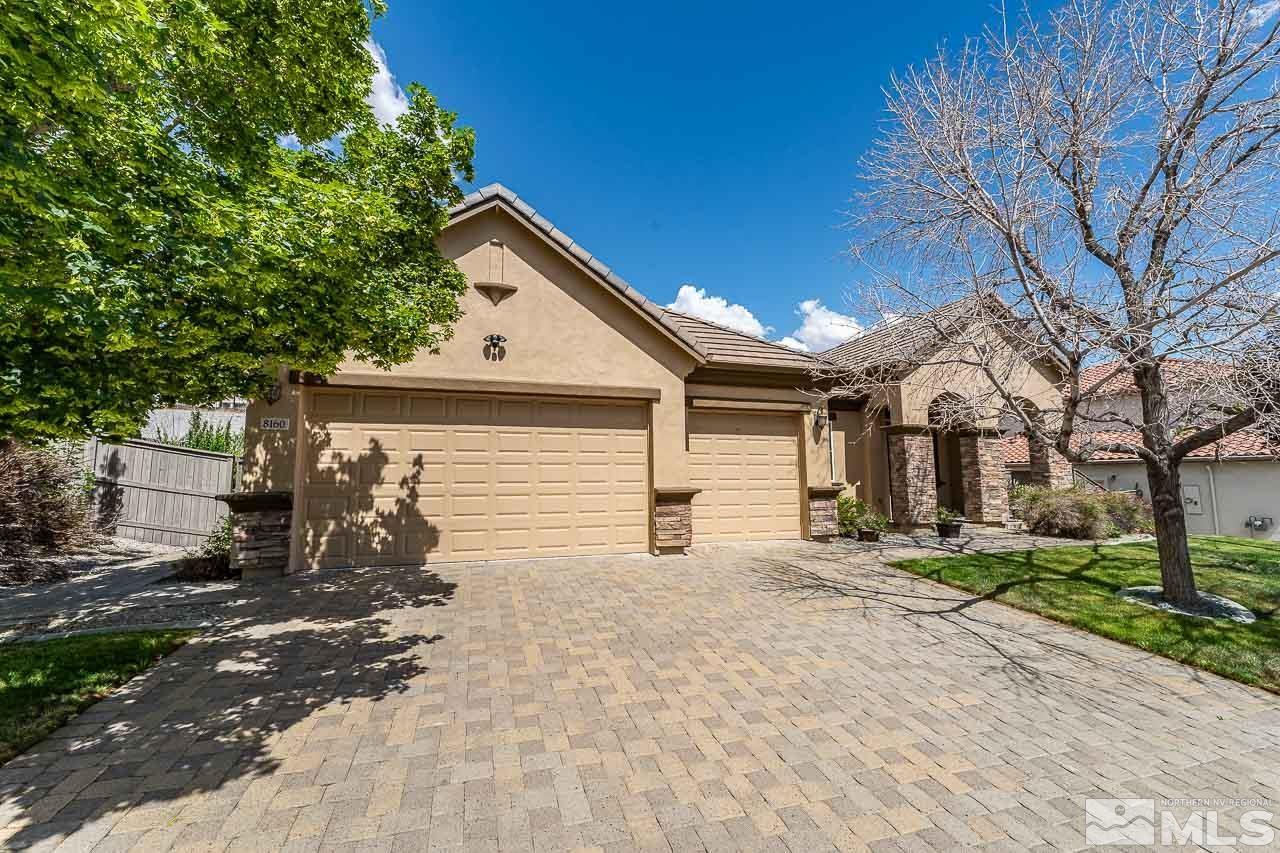 a view of a house with a yard and garage