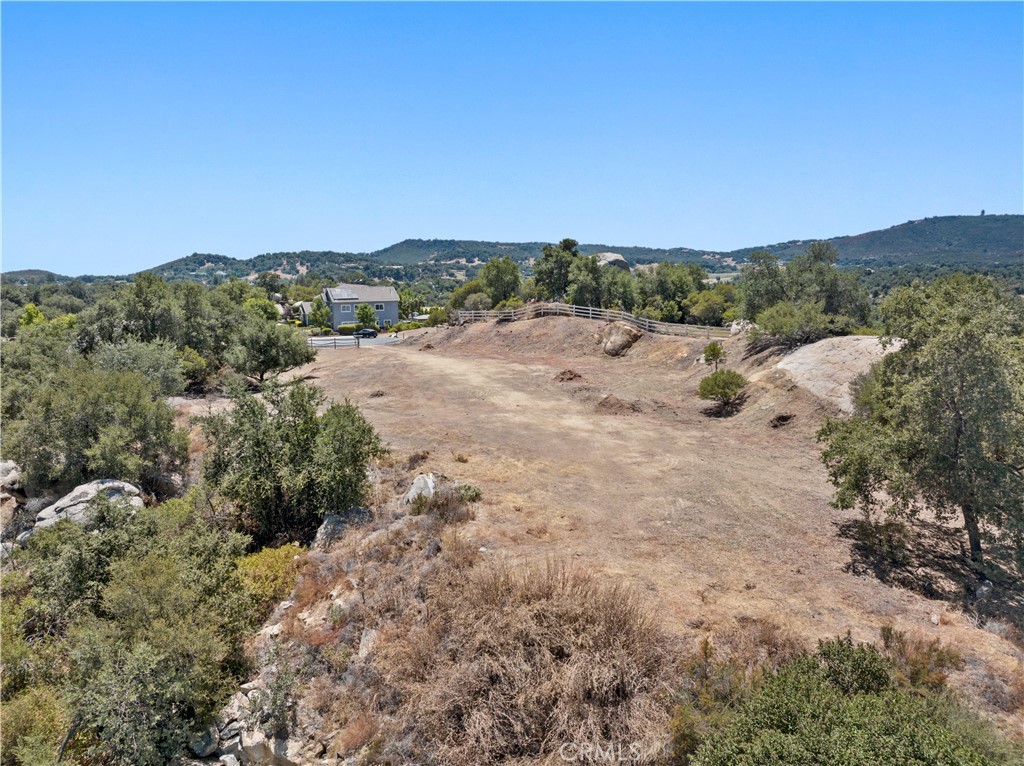 a view of a dry yard with mountains