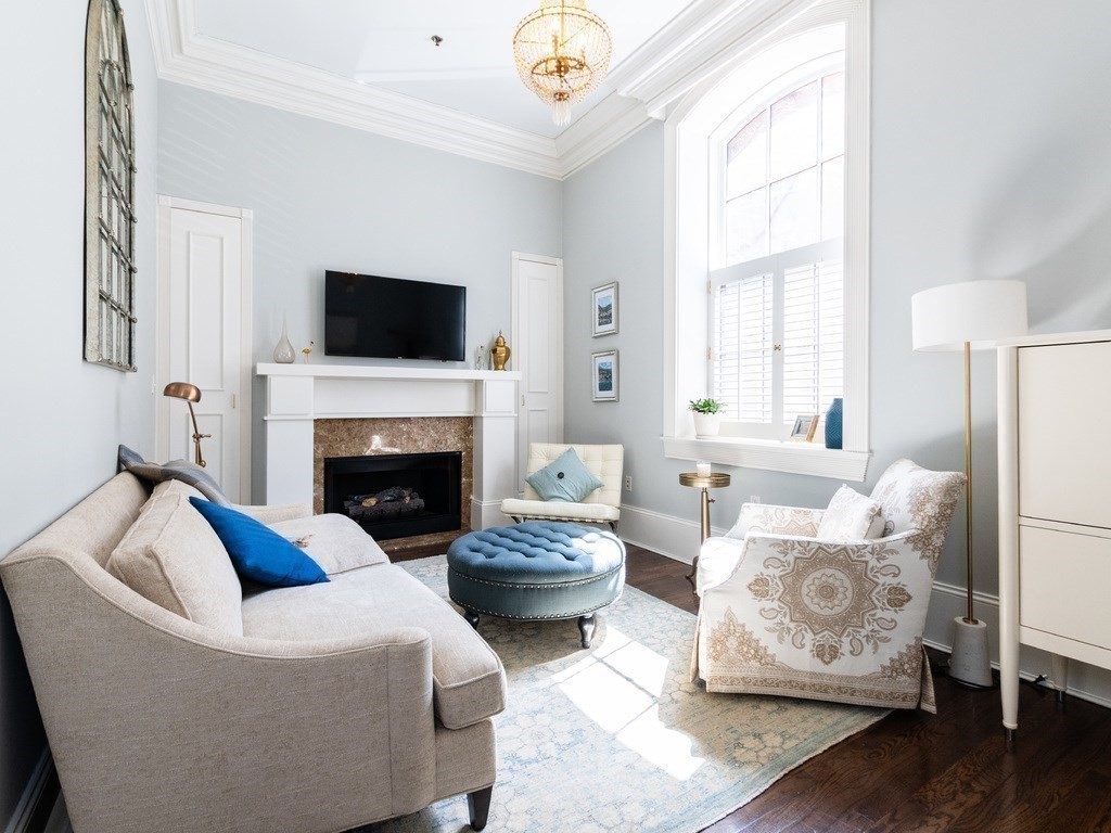 a living room with furniture and a fireplace