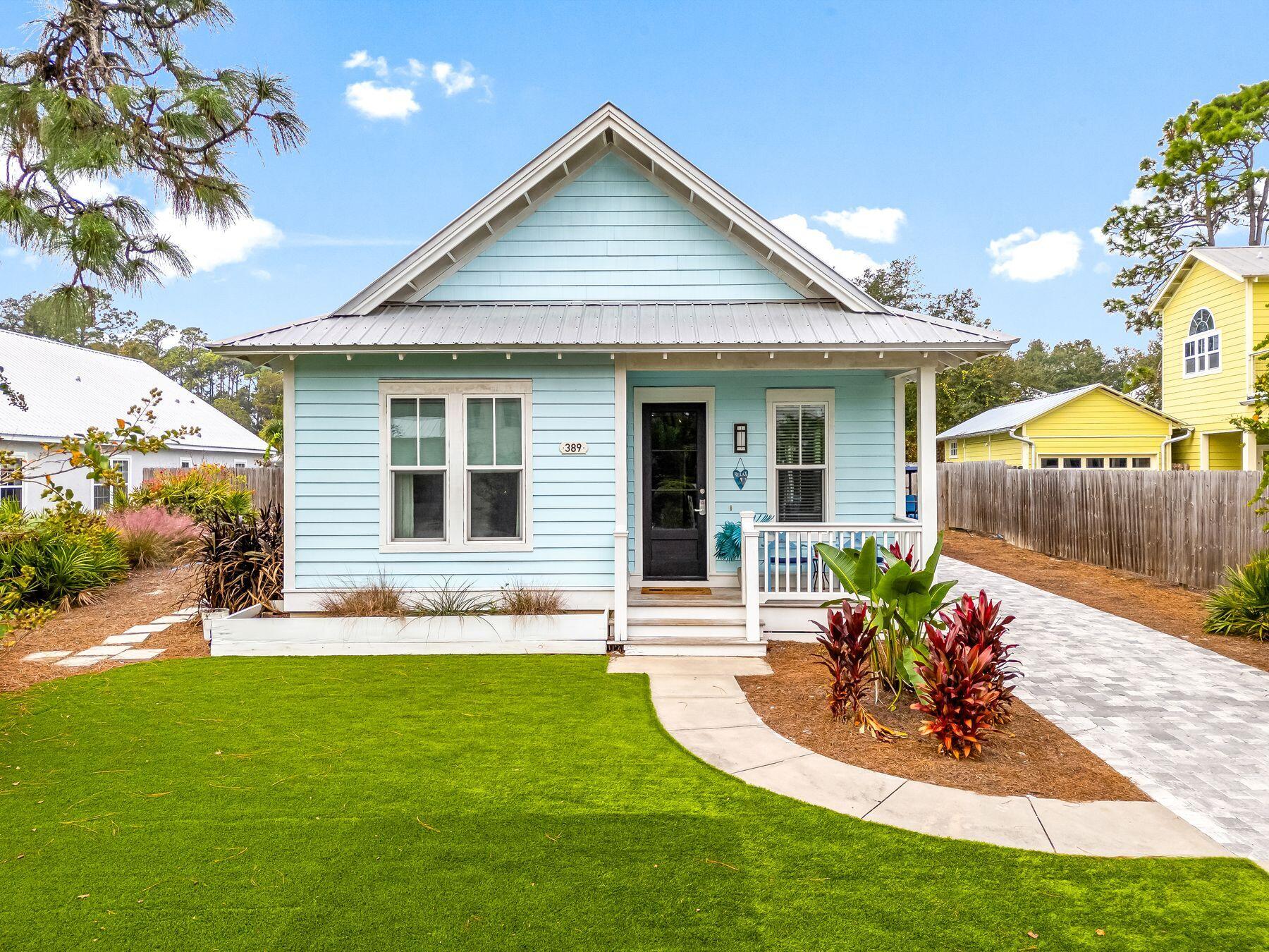 a front view of a house with a yard outdoor seating and garage