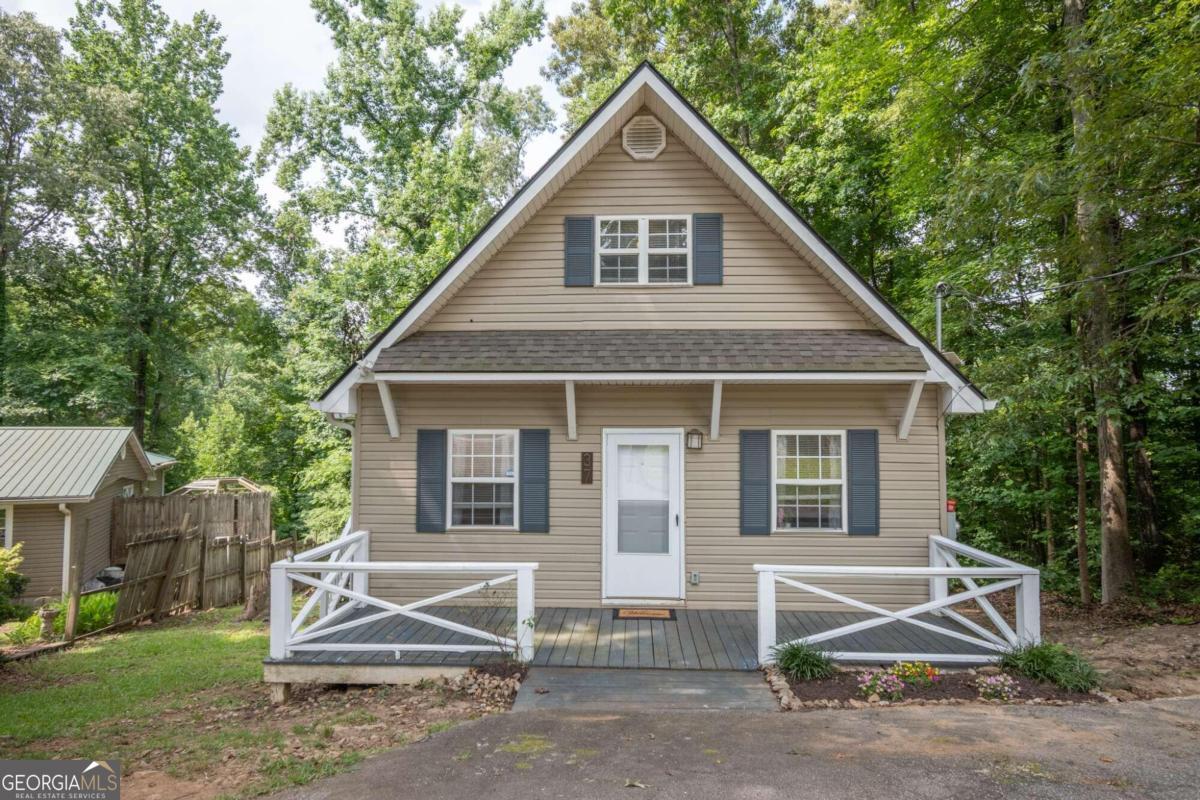 a view of a house with a yard and many windows