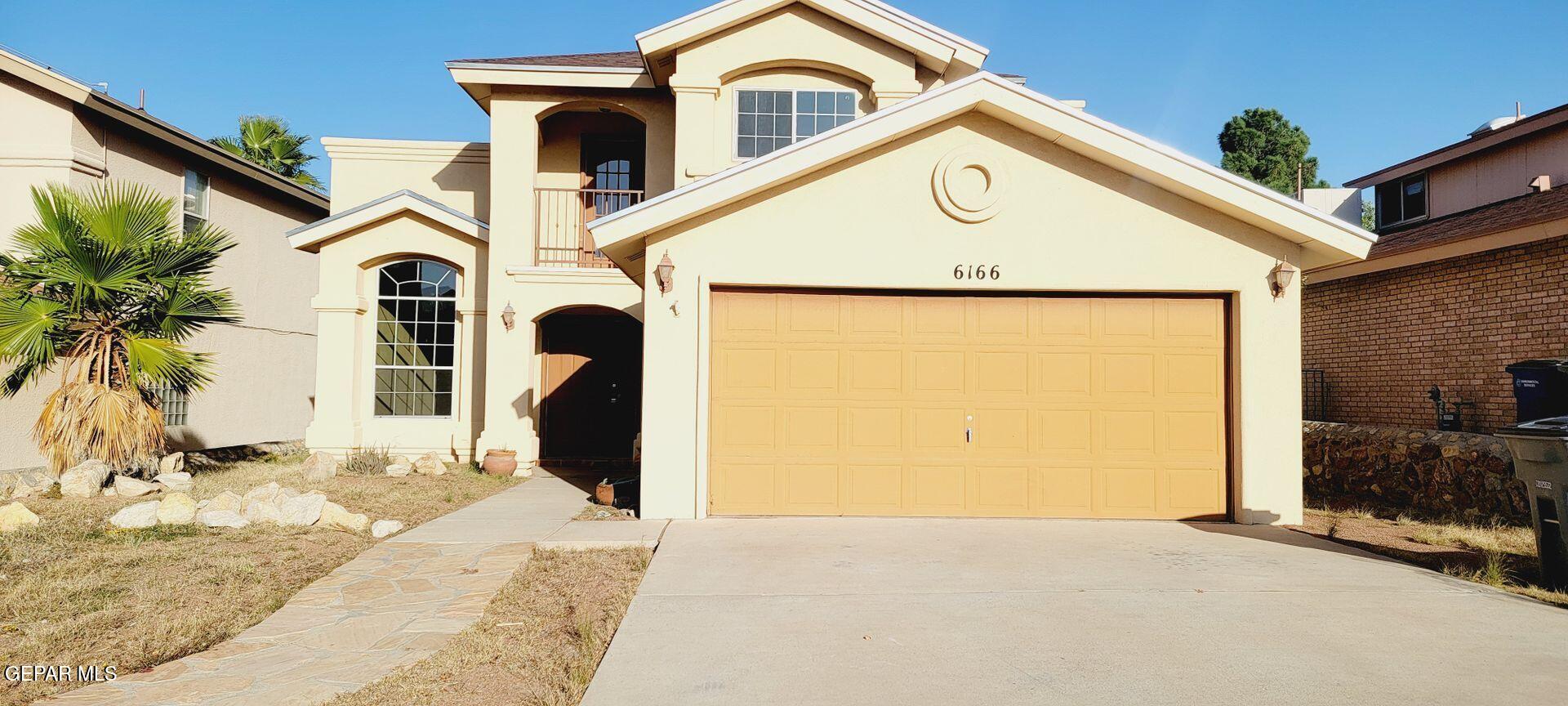 a front view of a house with parking